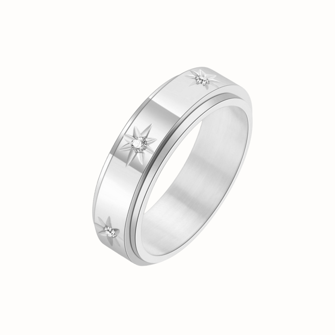 A gold stainless steel spinner ring with cubic zirconia stones, shown on a clean white background.