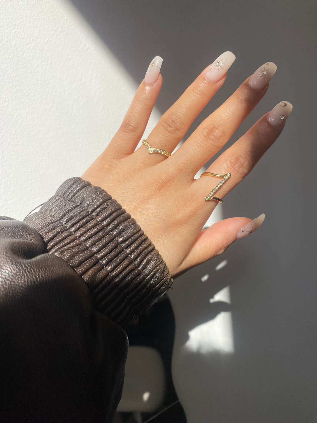 A sparkling wishbone-shaped stainless steel ring.