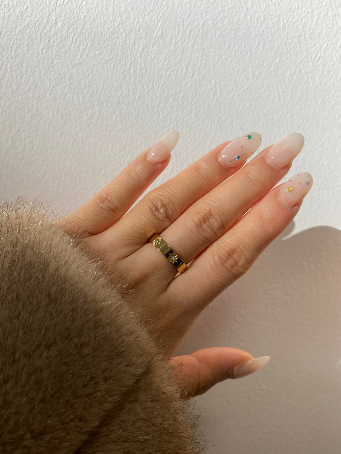 A gold Starburst Ring with three star-shaped accents, each featuring a cubic zirconia stone, displayed on a clean white background.