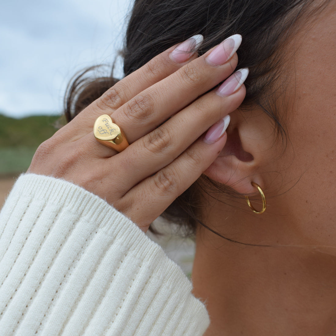 Stainless steel clip-on hoop earrings displayed on a clean white background.