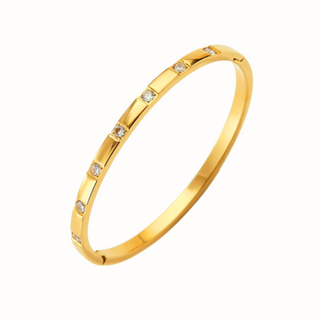 Gold diamond bangle bracelet with square CZ stones, with a clean white background.