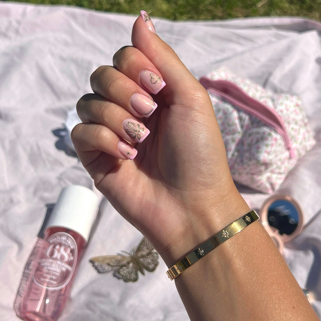 Gold-tone stainless steel starburst bangle bracelet with cubic zirconia.