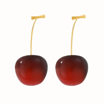 A close-up shot of the Oh My Cherry Earrings, featuring vibrant red cherries, set on gold-toned dangles.