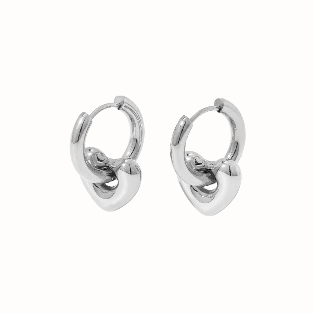 Detachable puffed heart huggie earrings in silver.