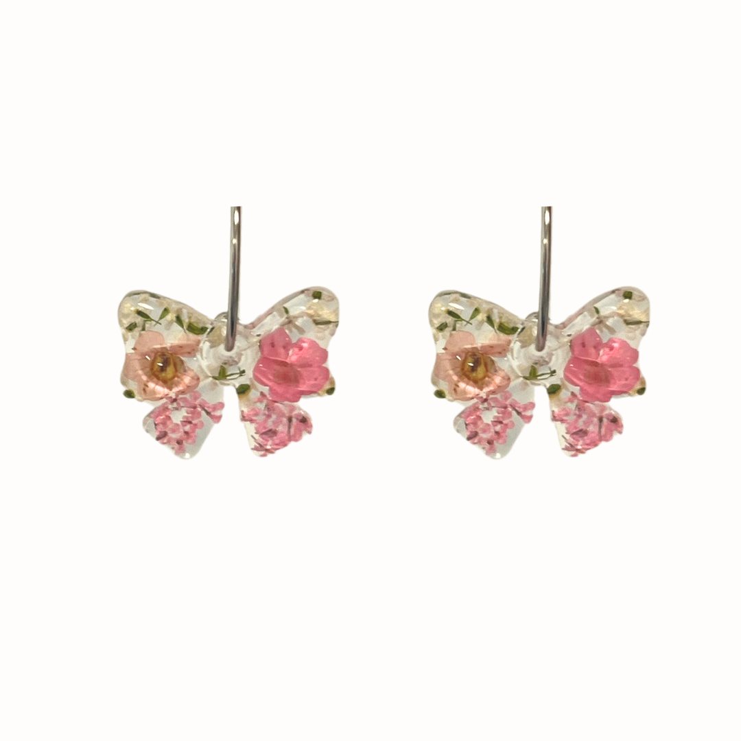 bow-shaped resin earrings with real dried flowers encased inside.