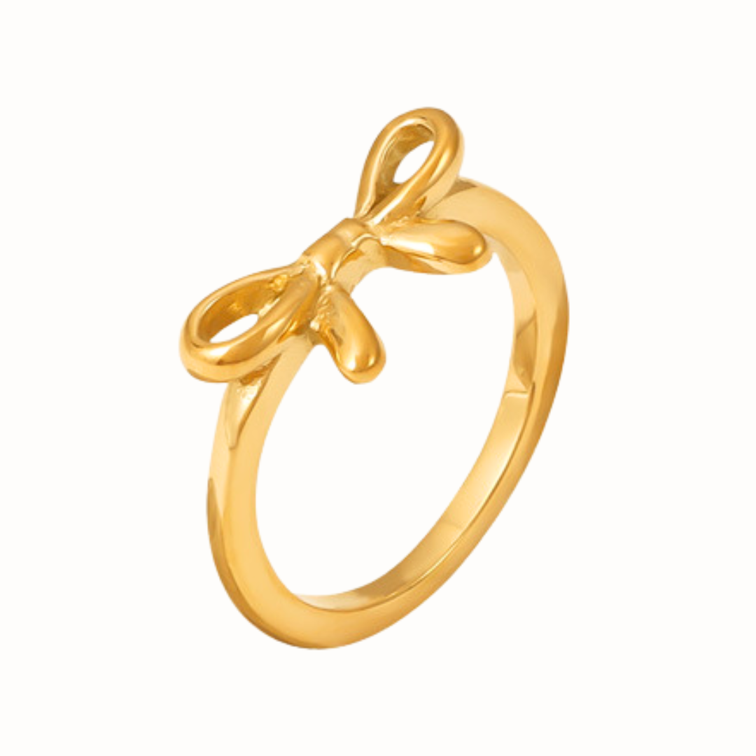 A gold Bow Ring featuring a delicate bow design.