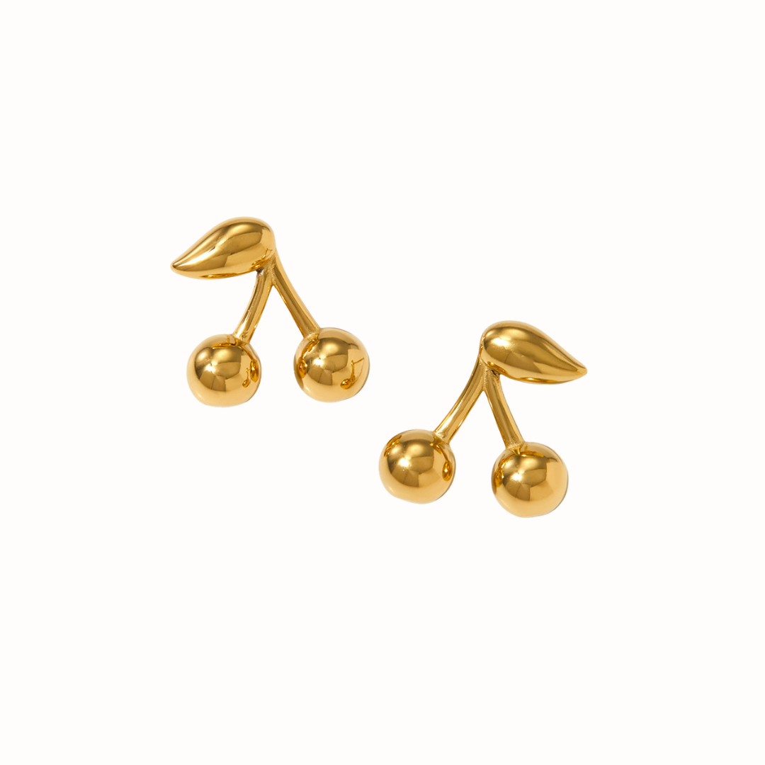 A close-up of small cherry-shaped stainless steel stud earrings.