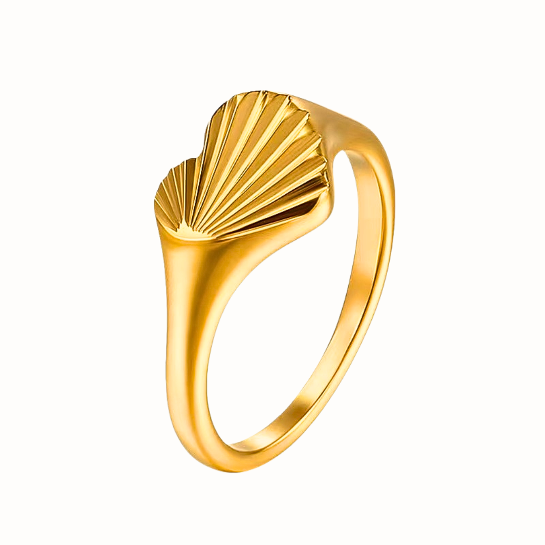 A gold Engraved Heart Ring with a radial-etched heart design, displayed on a white background.