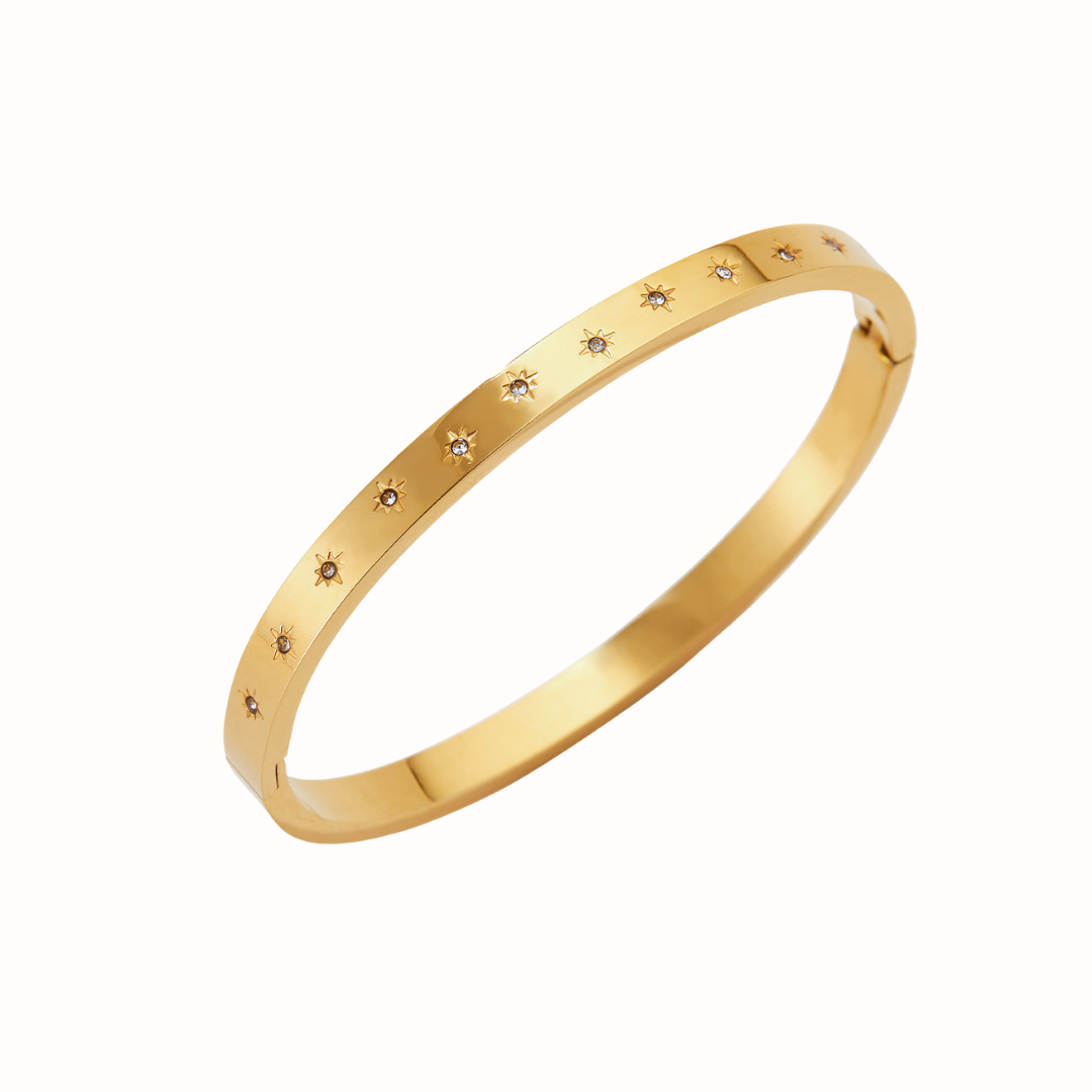 Stainless steel bangle bracelet with starburst cubic zirconia accents.

