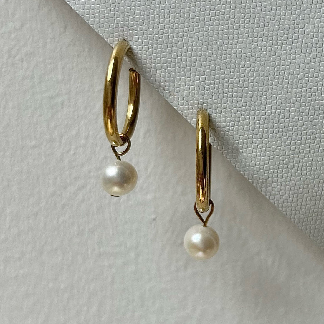 Gold freshwater pearl clip-on hoops.
