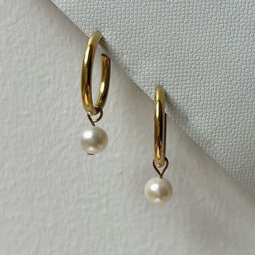 Gold freshwater pearl clip-on hoops.