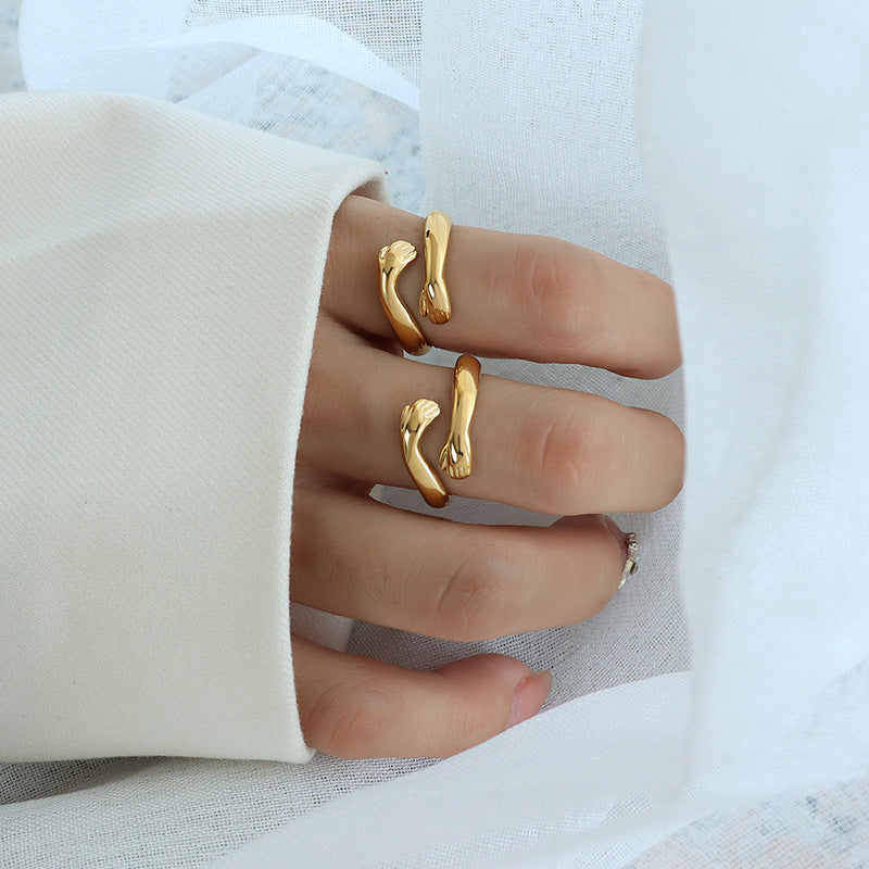 Gold rings on a person's fingers with a white background