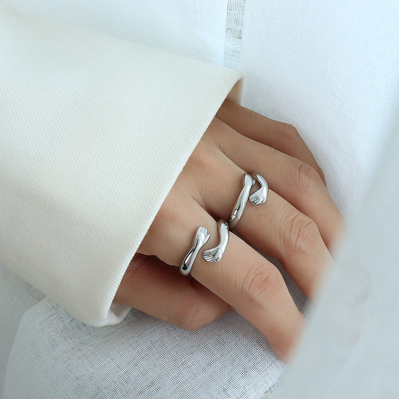 Silver ring on a finger against a white background