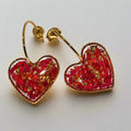 Heart-shaped resin earrings with real rose petals inside.