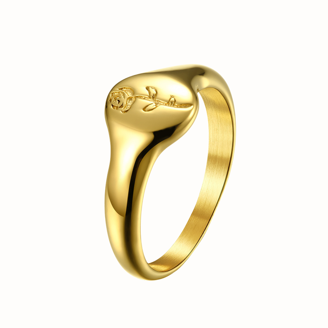 A gold stainless steel signet ring with an engraved rose design.