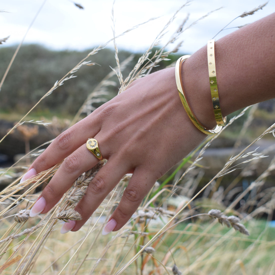 Polished stainless steel bangle bracelet with a sleek clasp.