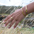 Polished stainless steel bangle bracelet with a sleek clasp.