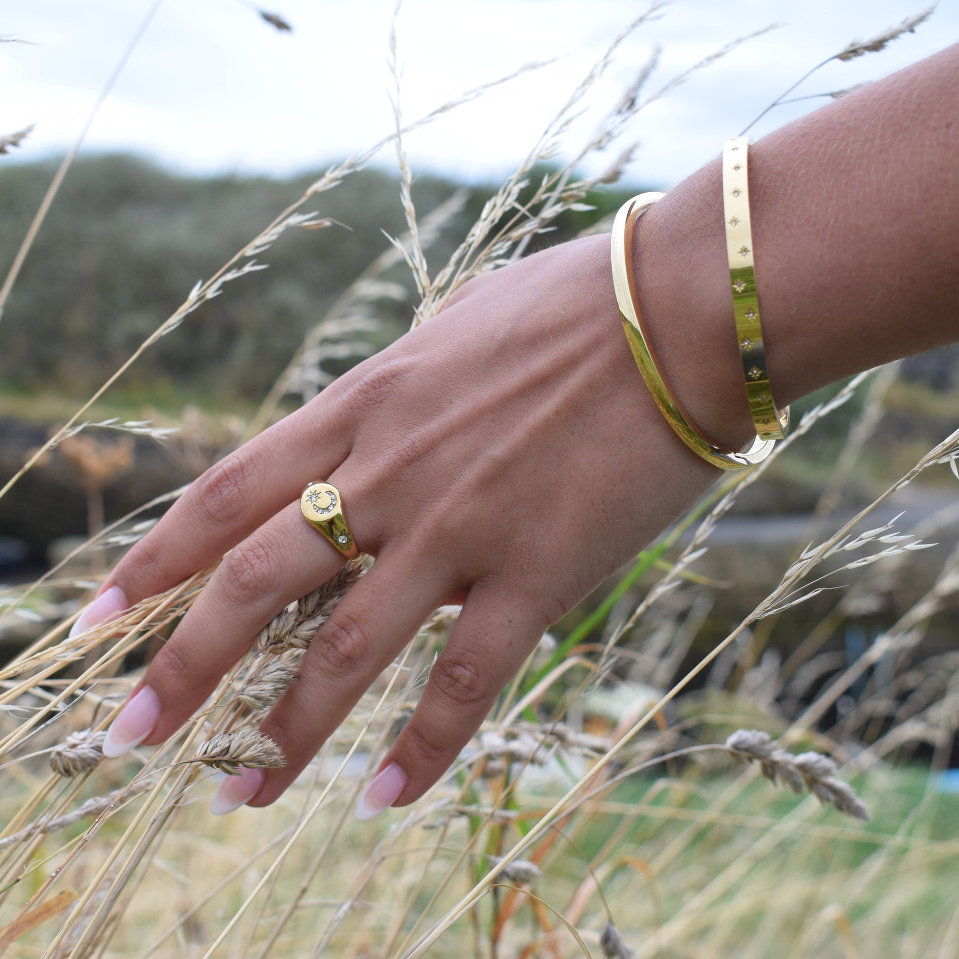 Polished stainless steel bangle bracelet with a sleek clasp.