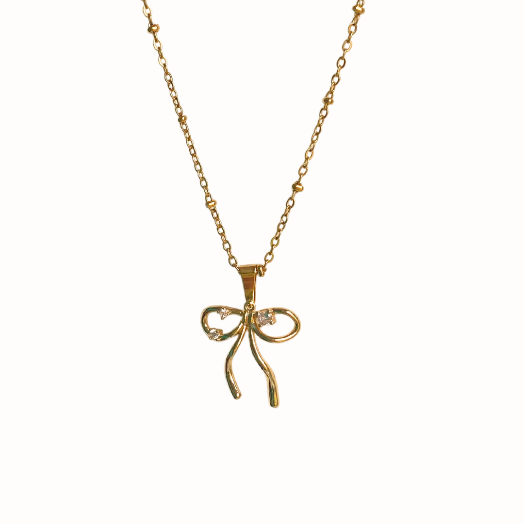 A bow-shaped necklace with sparkling CZ stones on a dotted chain.