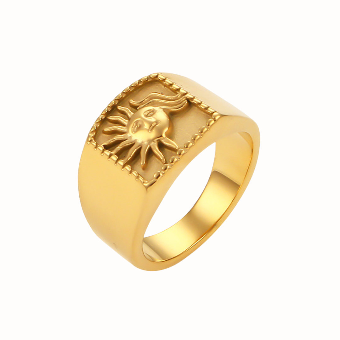 A gold stainless steel Sunburst Ring with a radiant sunburst pattern, shown on a clean white background.