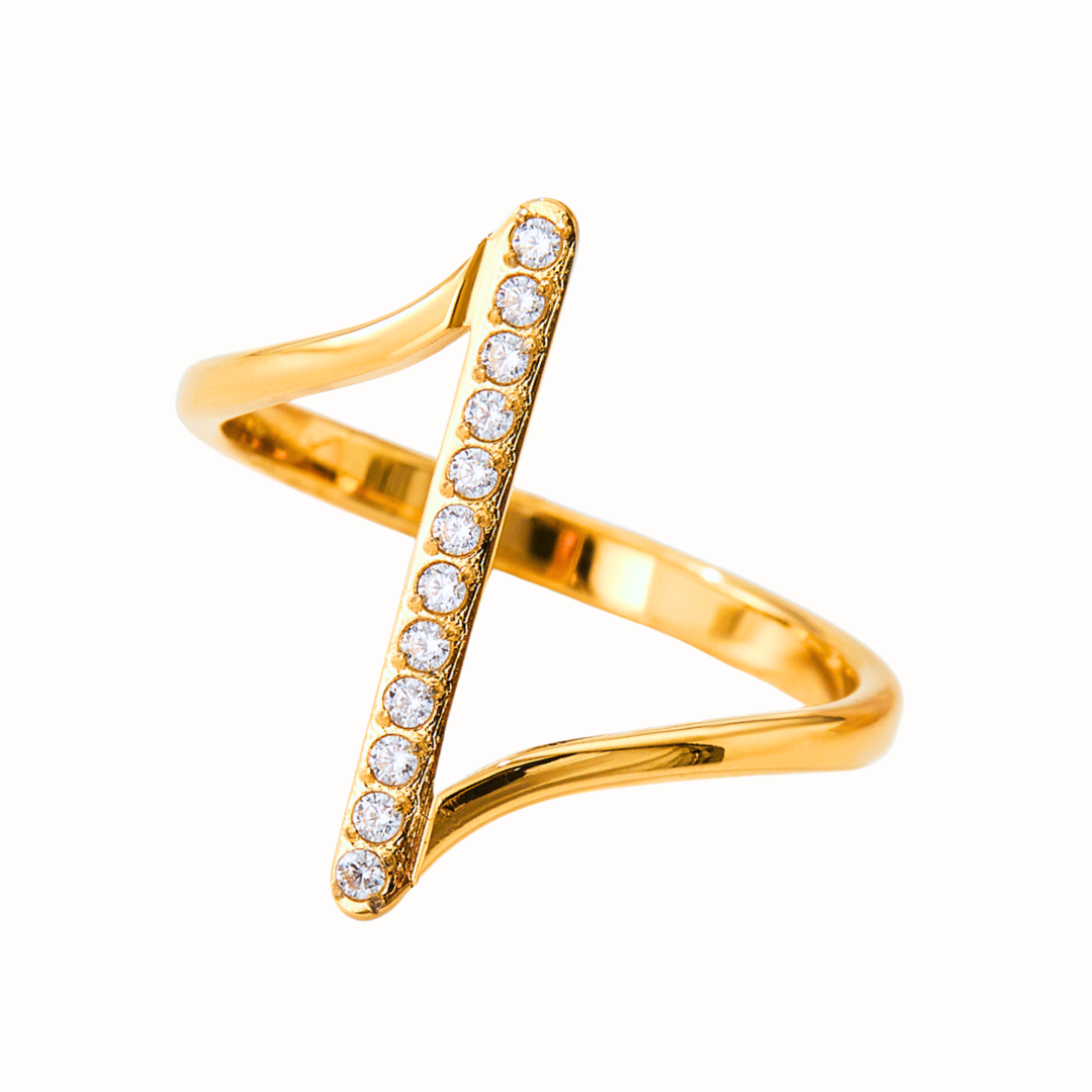 A gold Z-shaped stainless steel ring with cubic zirconia stones.